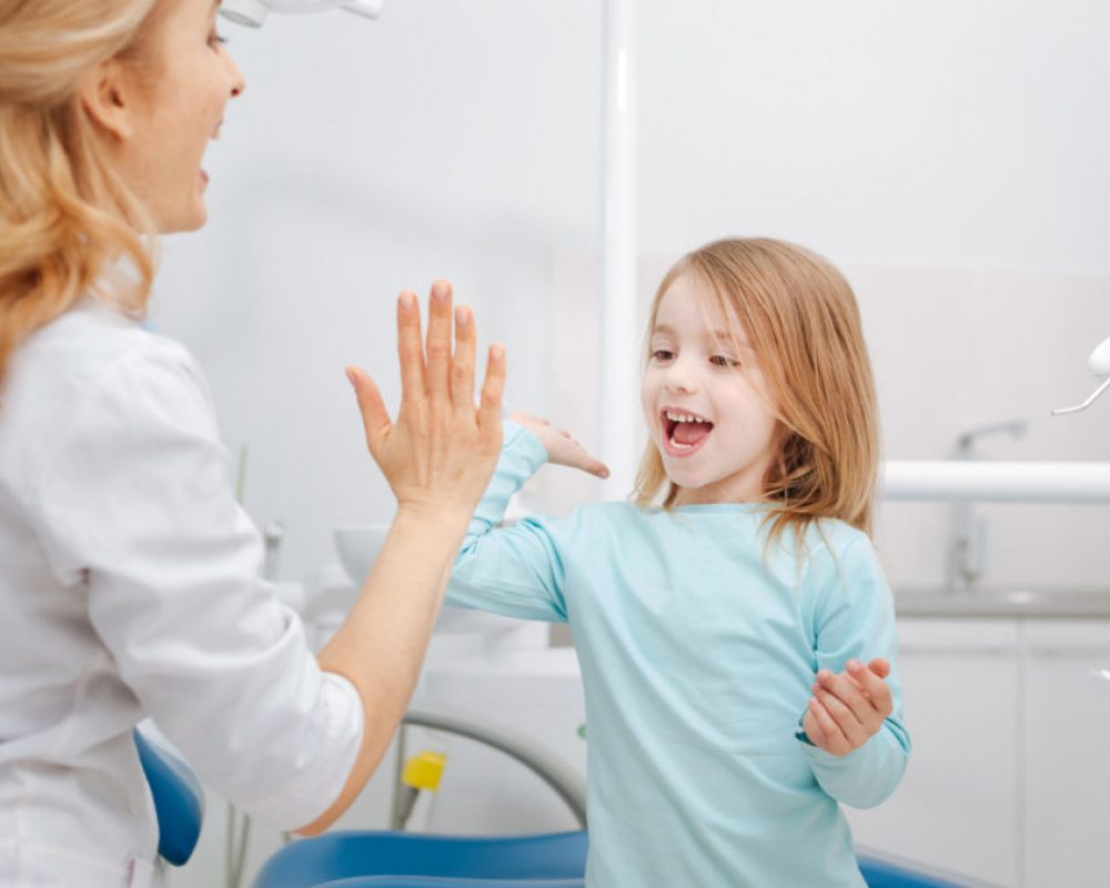 My little assistant. Trained capable distinguished doctor making friends with a girl after running some procedures and making her smile healthy